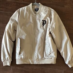 NWOT Primitive Cream Bomber Jacket with Black Logo. Men’s medium